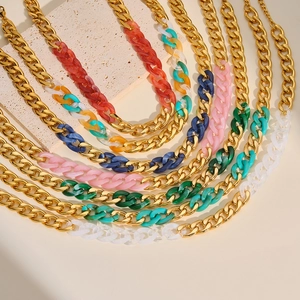 Close-up detail of trendy gold Cuban link chains with vibrant colorful acrylic segments.