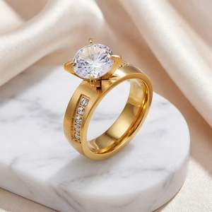 Close-up view of an elegant gold stainless steel four-prong solitaire diamond ring