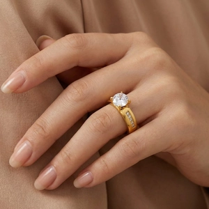 Detailed macro shot of an elegant four-prong stainless steel ring with a large clear stone