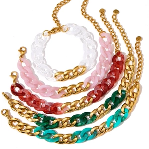 Close-up of dopamine style colorful acrylic and gold stainless steel chunky chain bracelets.