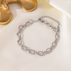 Minimalist silver stainless steel Cuban chain necklace with lobster clasp on silk fabric