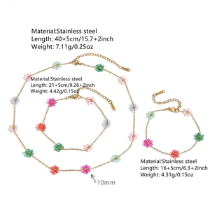 Close-up detail of stainless steel jewelry set featuring colorful acrylic flower beads