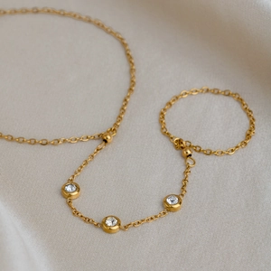 Detailed view of an 18K gold-plated titanium steel hand harness with zircon stones.
