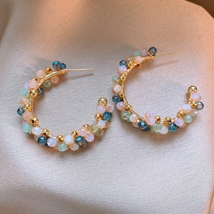 Close-up of French vintage hoop earrings with colorful crystal beads in Monet style