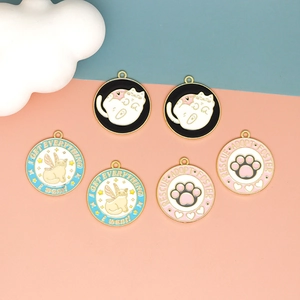Detailed view of colorful enamel cat charms with cute sayings for DIY jewelry