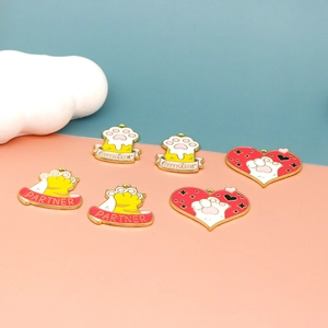 Detailed macro view of colorful cartoon cat paw and heart enamel alloy charms for DIY jewelry