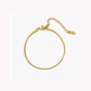 Detailed macro view of 316L stainless steel gold snake chain bracelet with lobster clasp