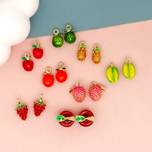 Macro view of colorful 3D fruit enamel charms for DIY jewelry making and accessories.