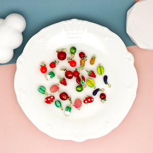 Detailed close-up of mini fruit and vegetable enamel charms for DIY jewelry making