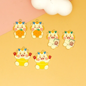 Detail view of cartoon dragon charms with orange, mahjong, and gold ingot designs