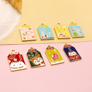 Detailed view of colorful alloy Omamori lucky charm pendants with cute animal designs