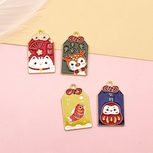 Close-up of four colorful Japanese-style Omamori charms with lucky animal patterns.