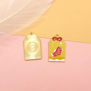 Detailed view showing front and back of lucky koi Omamori alloy charms with enamel