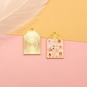 Detail view of lucky charm Omamori alloy pendant with cute rabbit design and radiant back