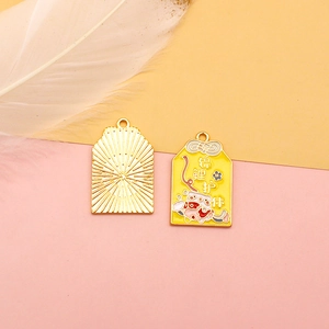 Detail view of yellow enamel Koi Omamori alloy pendant with lucky koi carp design