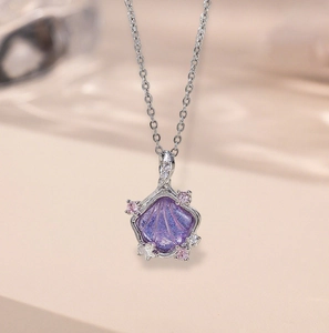 Elegant silver shell pendant necklace with purple enamel and ocean starfish charms
