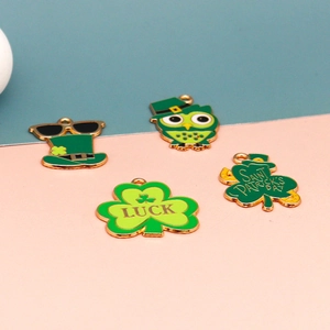 Close-up of green St. Patrick's Day enamel charms including shamrocks and leprechaun hats