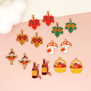 Detailed view of assorted Thanksgiving themed enamel charms including maple leaves