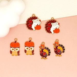 Detail showing a variety of cute Thanksgiving enamel charms featuring turkey, owl and hedgehog.