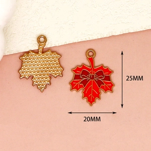 Detailed macro view showing 25mm by 20mm dimensions of red enamel maple leaf pendant.