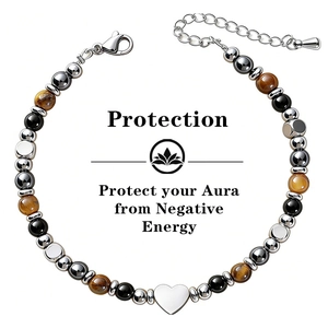 Detail of triple protection bracelet with tiger eye and obsidian beads and heart charm