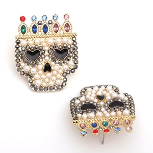 Detailed view of skull earrings with multicolored crystal crown and white faux pearls