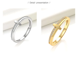 Detailed close-up showing gold and silver cross rings with cubic zirconia settings