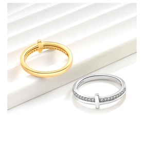 Macro view of gold minimalist cross ring and silver micro-paved cubic zirconia ring