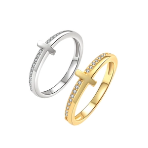 Cross rings set in gold and silver finish with pave zircon stones on white background