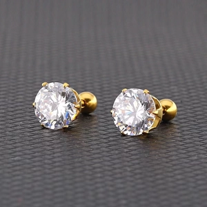 Macro shot of 6-prong gold-plated titanium steel studs with round-cut zircon and screw backs