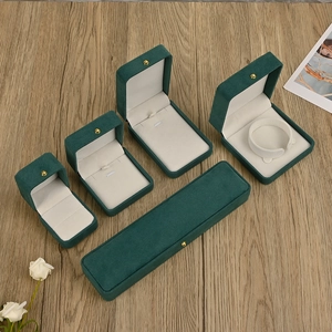 Deep green velvet jewelry box set with gold metal clasp for rings and necklaces
