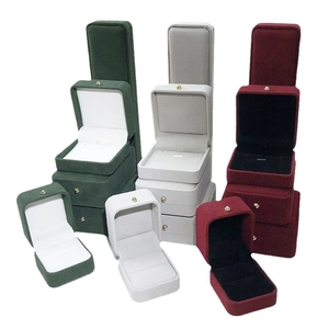 Velvet jewelry boxes with gold buckles for rings and necklaces in green, gray and red