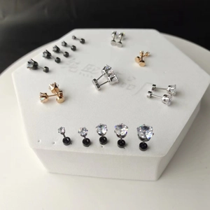 Macro shot of stainless steel stud earrings with cubic zirconia in gold, silver and black finish