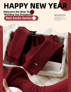 Detail of red combed cotton socks with small metal logo tag and warm knitted texture