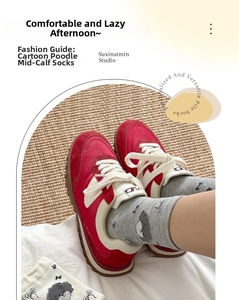 Detailed knit texture of mid-calf socks with cute curly dog and bone patterns