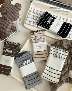 Detail of five pairs of striped cotton crew socks with ruffle edges and woven labels