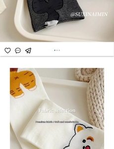 Detail view of cotton knit socks with cute cartoon animal patterns in gray and cream
