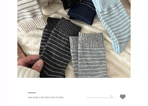 Close-up of striped wool mid-tube socks with soft knit texture in grey-blue palette