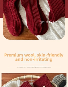 Close-up of red wool socks featuring thick rib knit texture and warm folded cuffs