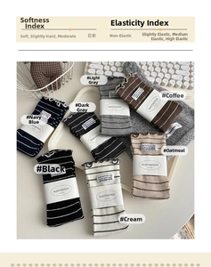 Detailed macro view of seven pairs of ribbed cotton socks with minimalist brand labels