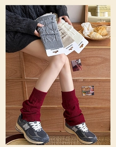 Detailed knit texture of vintage cable-knit leg warmers in various colors for women