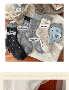 Detail of wool socks showing cute puppy embroidery and polka dot patterns in five colors