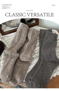 Close-up of thick ribbed knit wool socks showing soft texture and warm winter material