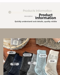 Detail view of striped wool socks in black navy and gray colors on a cozy wooden table