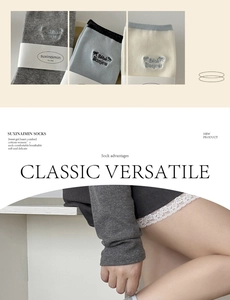 Detail of embroidered bow and letter motif on combed cotton crew socks in grey and blue