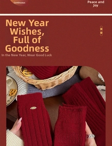 Detail of red ribbed wool socks featuring a small metal tag and cozy winter texture