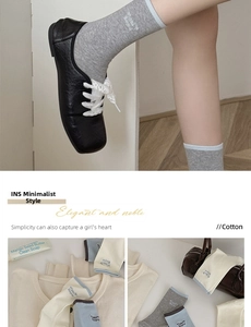 Detail of embroidered cotton mid-calf socks with contrast cuffs in grey and beige