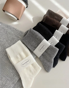 Close-up of ribbed texture cotton mid-calf socks in various neutral earth tones