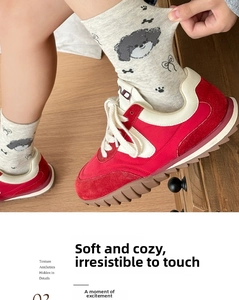 Detailed knit of grey crew socks featuring cute dog patterns and musical notes on feet