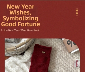 Detailed texture of red wool knit socks with gold metal tag and branded fabric label